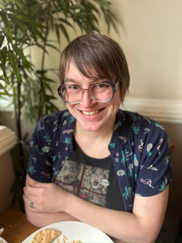 Austen Tucker smiling in glasses.